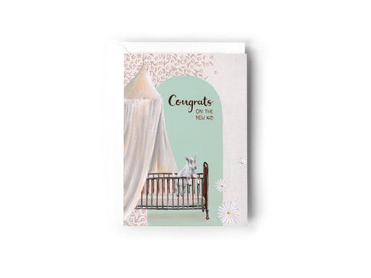A baby shower / new baby congratulations card featuring an illustration of a white goat in a retro brass crib under a flowing bed canopy, with a mint green arch and the text 'Congrats on the NEW KID' by Australian Artist, Jessica Alpert. The card has a white envelope behind it and sits on a white background.