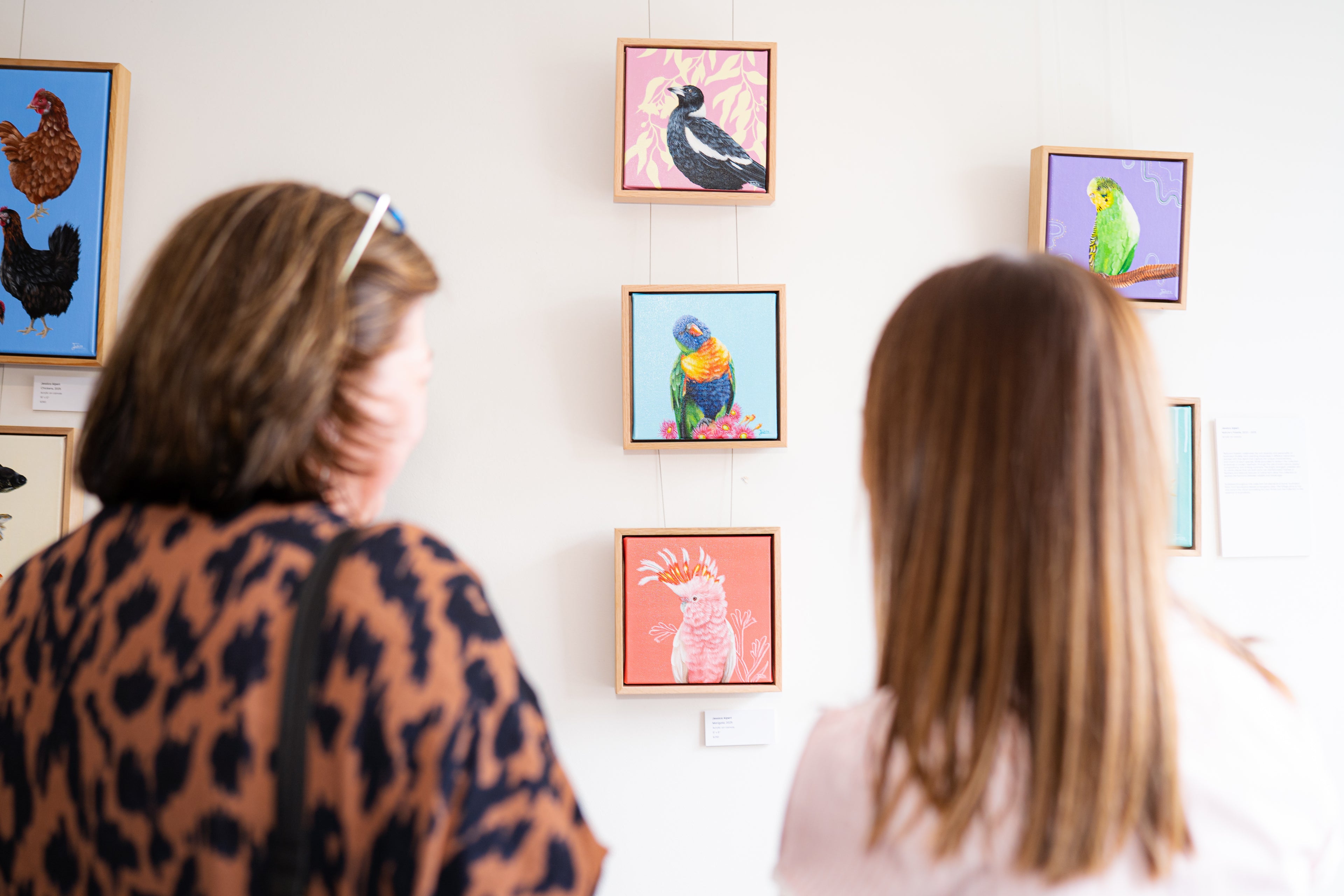Australian Artist Jessica Alpert and friend discussing Jessicas original acrylic paintings at her 'Wild Whimsy' exhibition held in the Yarra Valley in 2025.