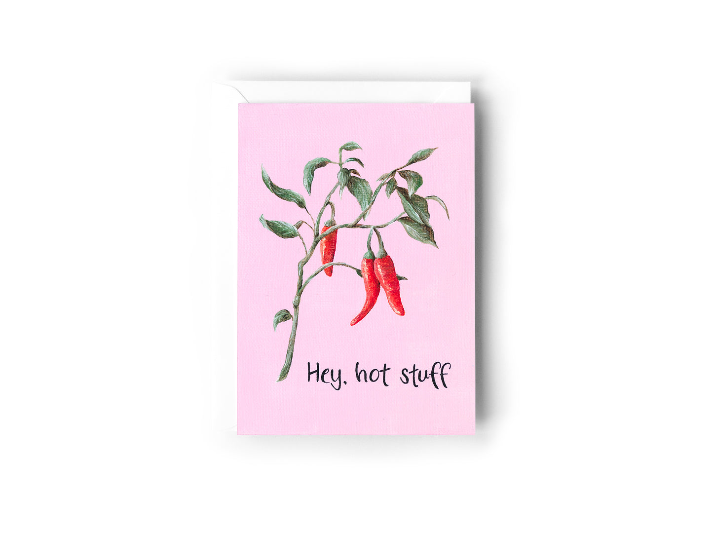A greeting card design hand painted by Australian Artist Jessica Alpert featuring a chilli plant illustration on a pink background with the words 'Hey, hot stuff'. The card has a white envelope behind it and sits on a white background.