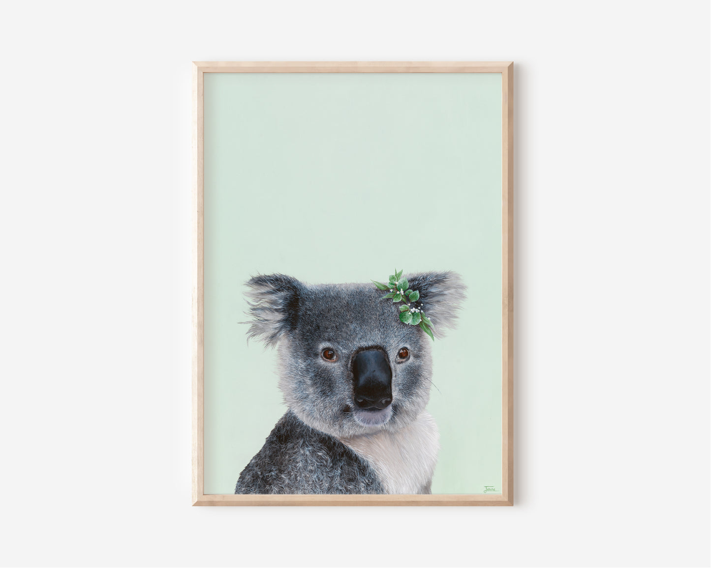 A Fine Art Print hand painted by Australian Artist Jessica Alpert of a detailed fluffy koala smiling with a leaf crown on it's right ear, sitting against a soft green background.