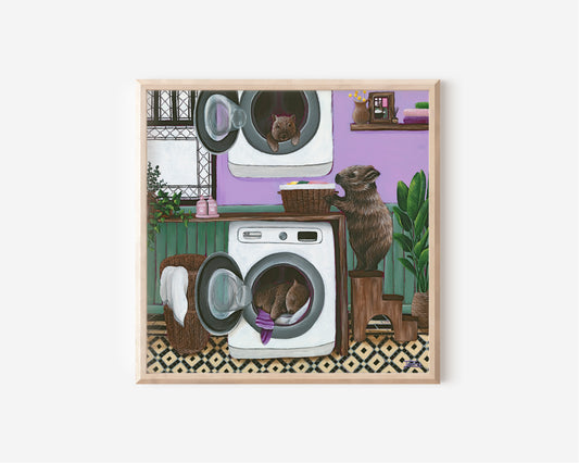 Fine Art Print by Australian Artist Jessica Alpert of a family of Australian wombats in a colourful and quirky laundry setting. One baby wombat sleeps amongst warm washing in the washing machine, another hangs out of the dryer playfully, and the Mum wombat completes the washing chores.