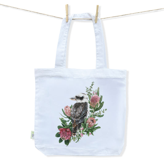 White tote bag with a detailed design of an Australian Kookaburra perched amongst an array of pretty Australian foliage and florals by Australian Artist Jessica Alpert.