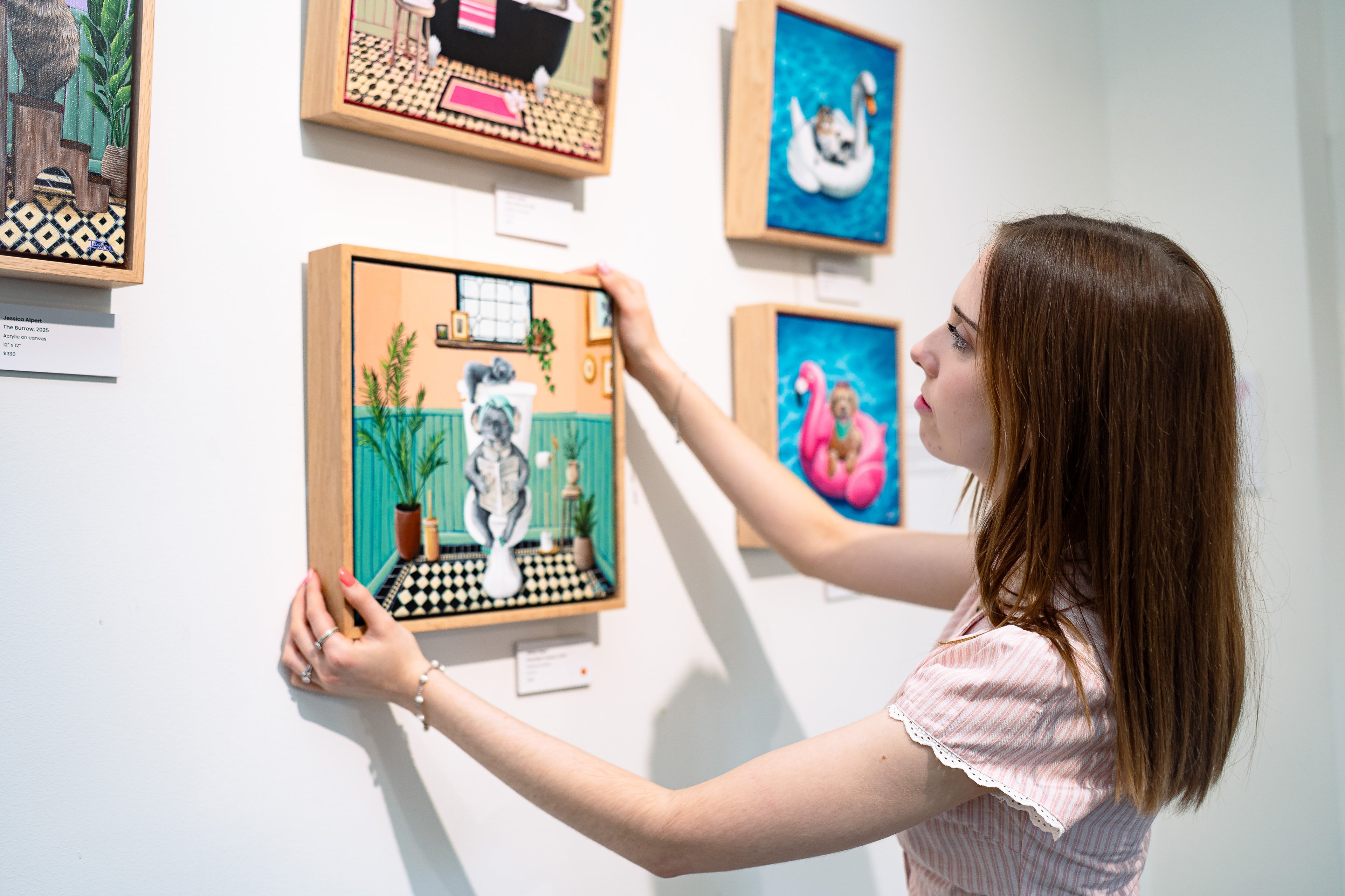 Artist Jessica Alpert observing her 'Drop Bear Invasion' acrylic painting from her 'Creature Comforts' collection of paintings at her 'Wild Whimsy' exhibition.