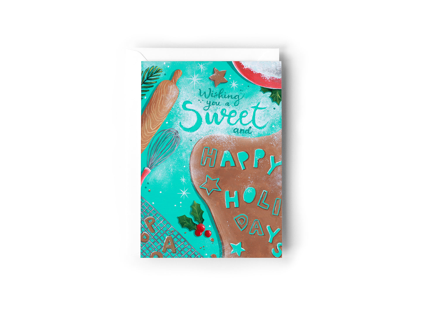 A festive Christmas greeting card featuring a turquoise background with illustrations of a gingerbread cookie, a rolling pin, a whisk, holly, and the words 'Wishing you a Sweet and HAPPY HOLIDAYS' by Australian Artist Jessica Alpert. The card has a white envelope behind it and sits on a white background.